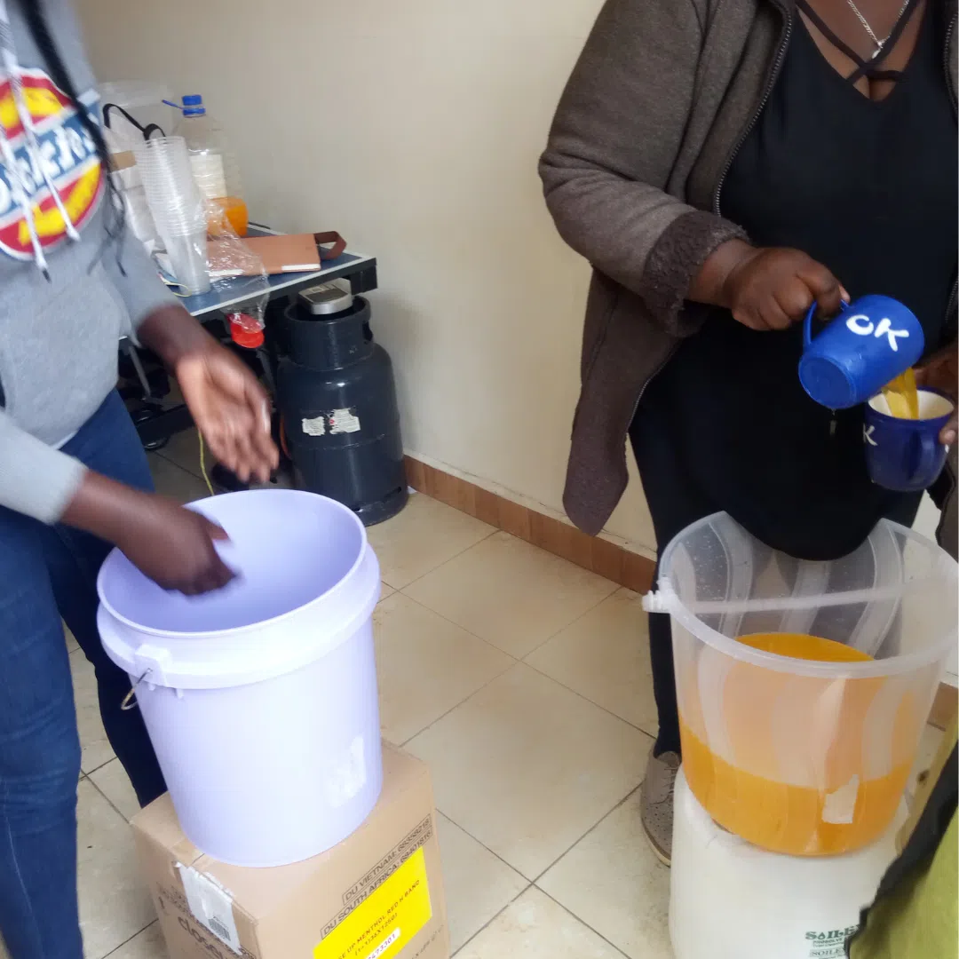 Kenyan mothers and volunteers make food for the kids